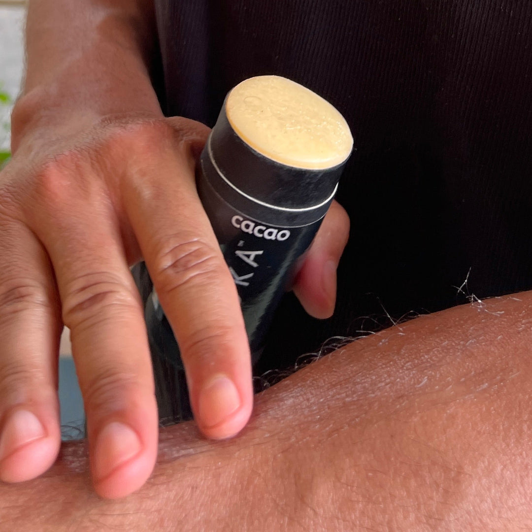MOKA body butter stick being swiped along a forearm