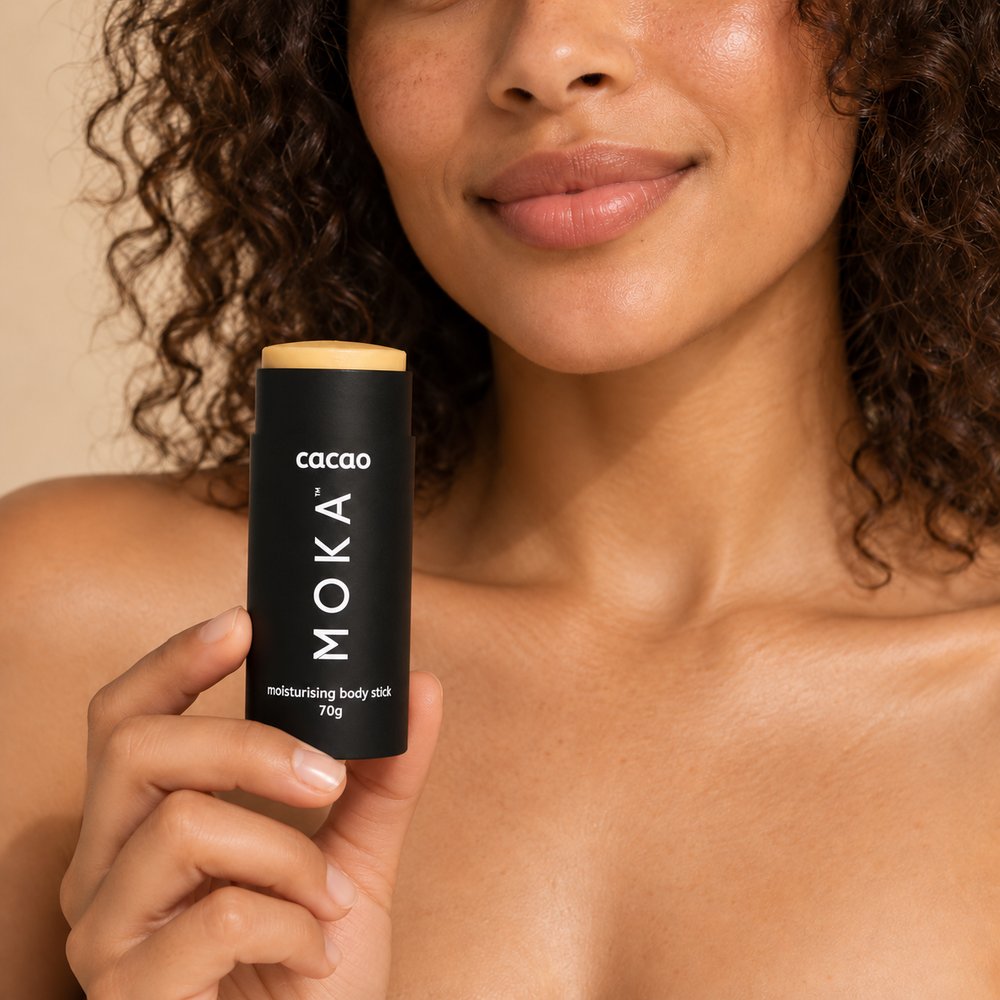 A woman holding the MOKA cacao body butter stick